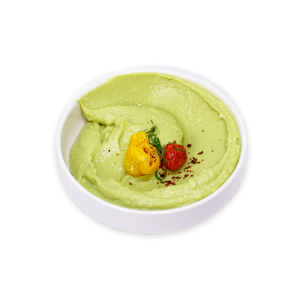 Avocado Hummus garnished with roasted tomatoes in a white bowl